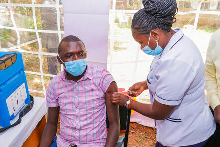 A medic vaccinating a person.