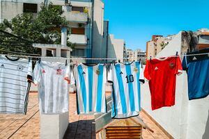 A selection of football shirts hanging on a washing line