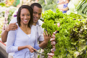 Couple buying fresh nutritional produce in supermarket as part of a healthy and balanced lifestyle 
