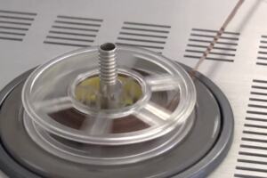 An image of a 3.75 inch reel-to-reel magnetic tape running through a tape machine