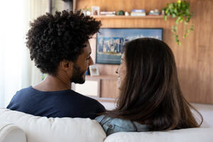 Multi-ethnic couple watching TV