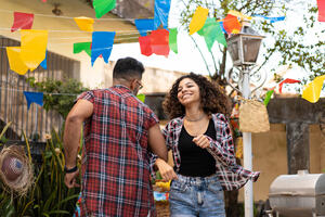 Spanish/Latin American couple dancing in backyard